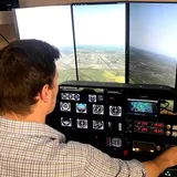 Pilot Rise flight instructor beside a training airplane